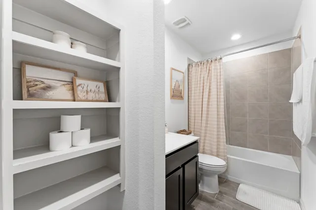 a bathroom with a toilet sink and shower