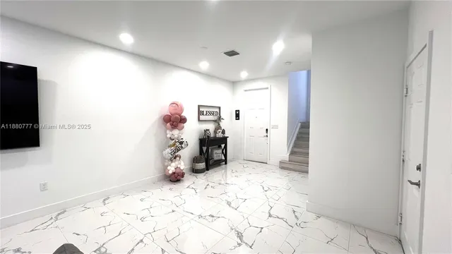 a kitchen with a dining table chairs and microwave