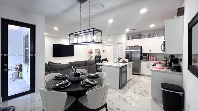 a kitchen with a table and chairs in it