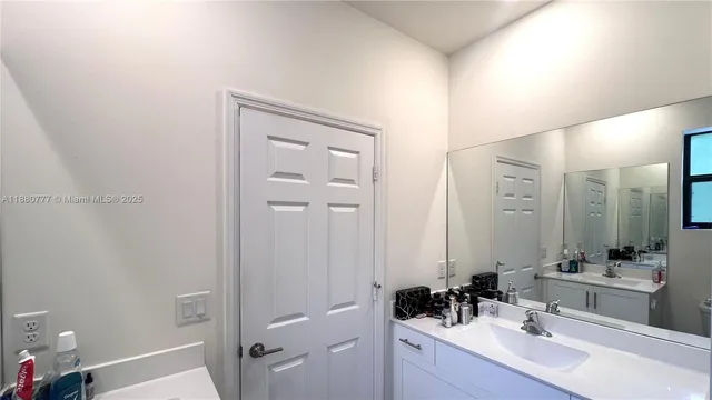 a bathroom with a sink a mirror a shower and a sink