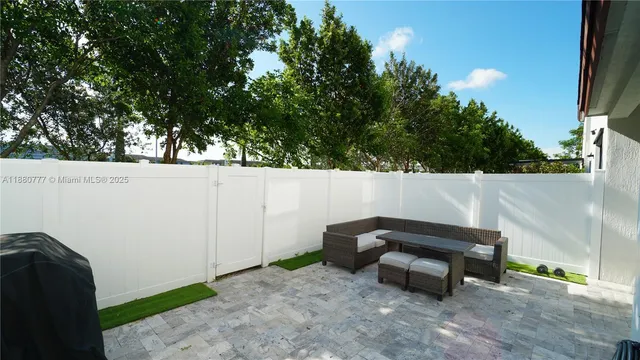 a backyard of a house with table and chairs