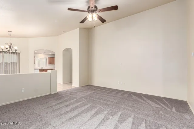 a view of a kitchen with wooden cabinet and a ceiling fan