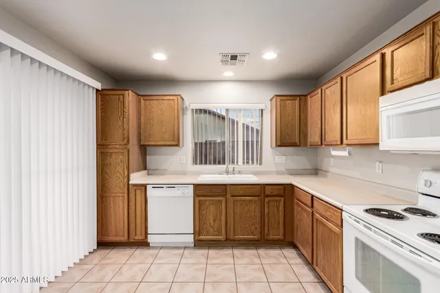 a kitchen with a stove sink and cabinets