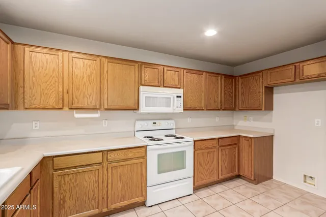 a kitchen with white cabinets and white appliances