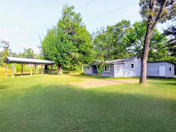 a view of a house with pool and tree s