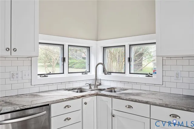 a kitchen with stainless steel appliances a table chairs sink and stove top oven