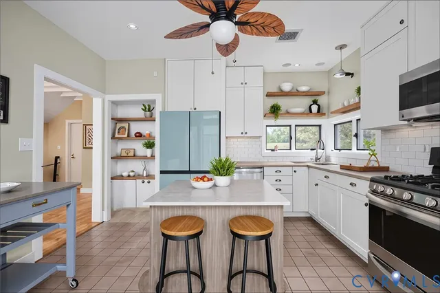 a kitchen with a refrigerator a stove top oven and cabinets