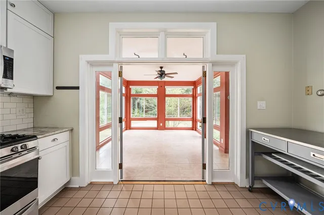 a living room with furniture and a floor to ceiling window