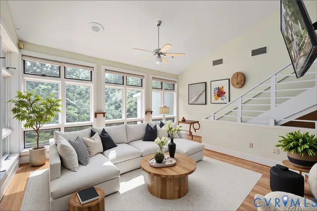 a view of an empty room with wooden floor and a fireplace