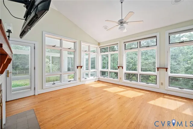 a view of a room with wooden floor and windows