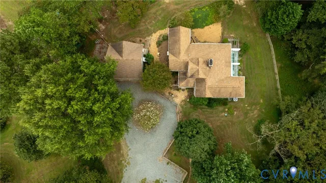 an aerial view of residential houses with outdoor space and trees