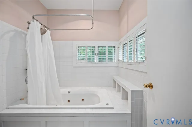 a spacious bathroom with a double vanity sink and mirror