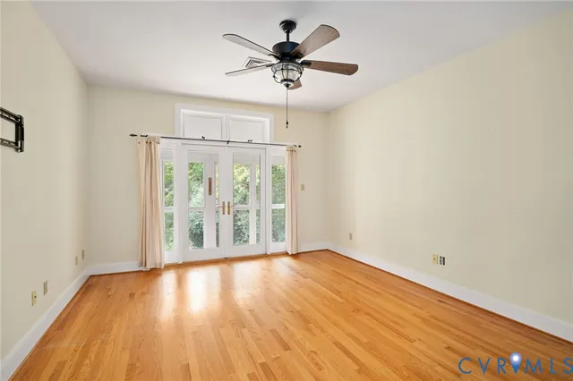 a view of a room with wooden floor and windows