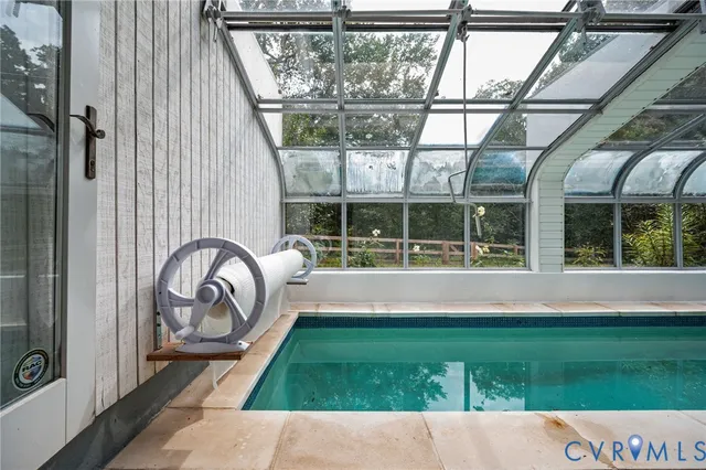 a view of an empty room with a fireplace and a window