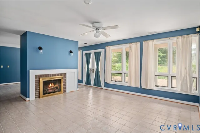 a bedroom with a bed chandelier and a window