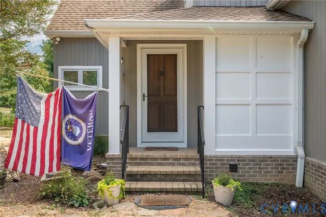 a front view of a house with potted plants