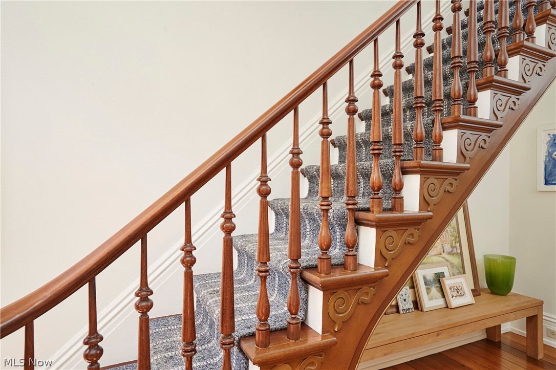 5046 Alger Road Richfield, OH 44286 - Photo 29 of 49 Crafted wood staircase featuring an ornate balustrade, turned spindles, and carved newel posts