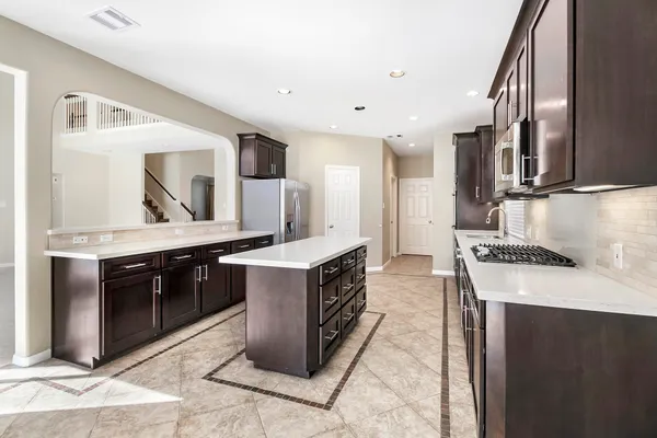 a bathroom with a granite countertop double vanity sink and a mirror