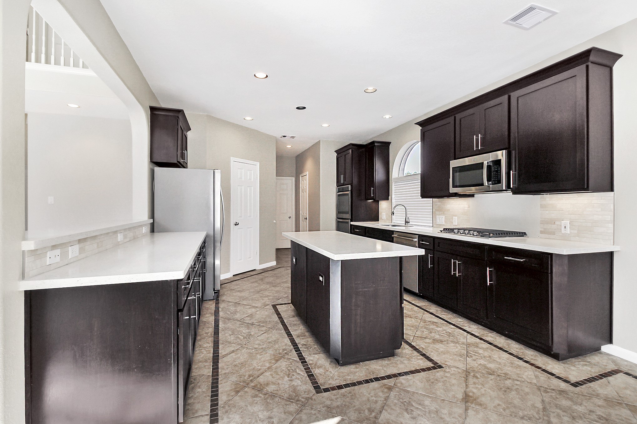 803 Chisel Point Drive Houston, TX 77094 - Photo 15 of 36 a kitchen with stainless steel appliances granite countertop a stove a sink dishwasher a refrigerator and a microwave oven
