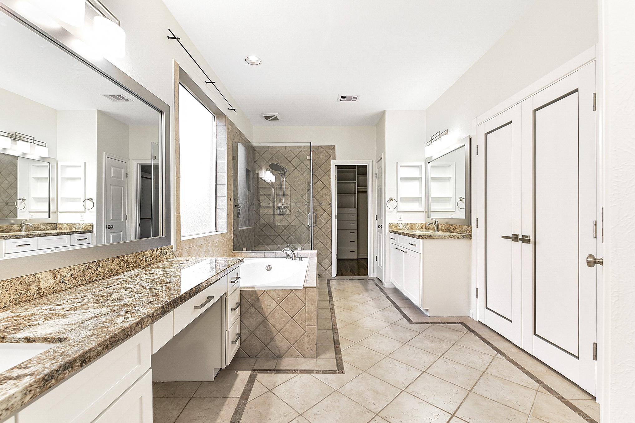 803 Chisel Point Drive Houston, TX 77094 - Photo 22 of 36 Primary bathroom with separate vanities and beautiful contemporary light fixtures. New cabinets and fresh paint.