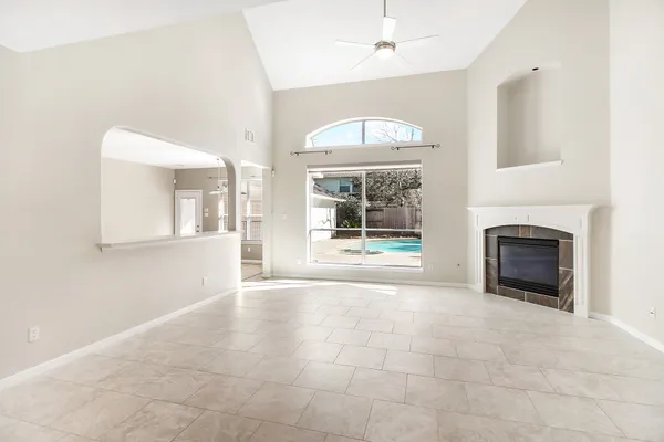 a large white kitchen with a double vanity sink and a refrigerator