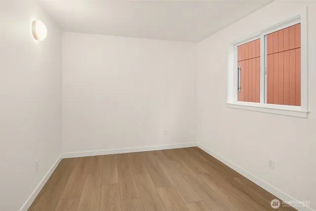 a bedroom with a bed and a large window