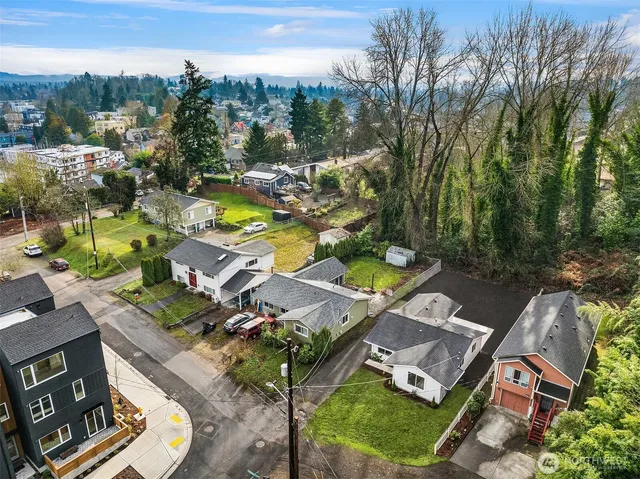 an aerial view of residential building with outdoor space and ocean view