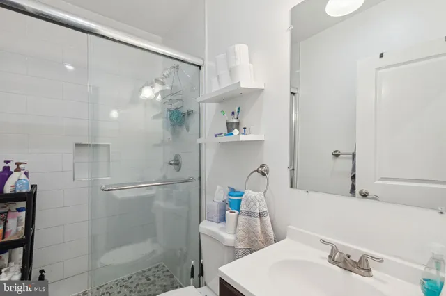 a bedroom with a bed couch and a window