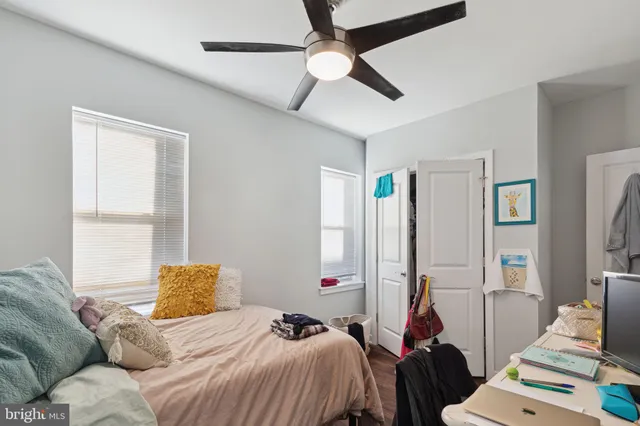 a bedroom with a bed and a desk