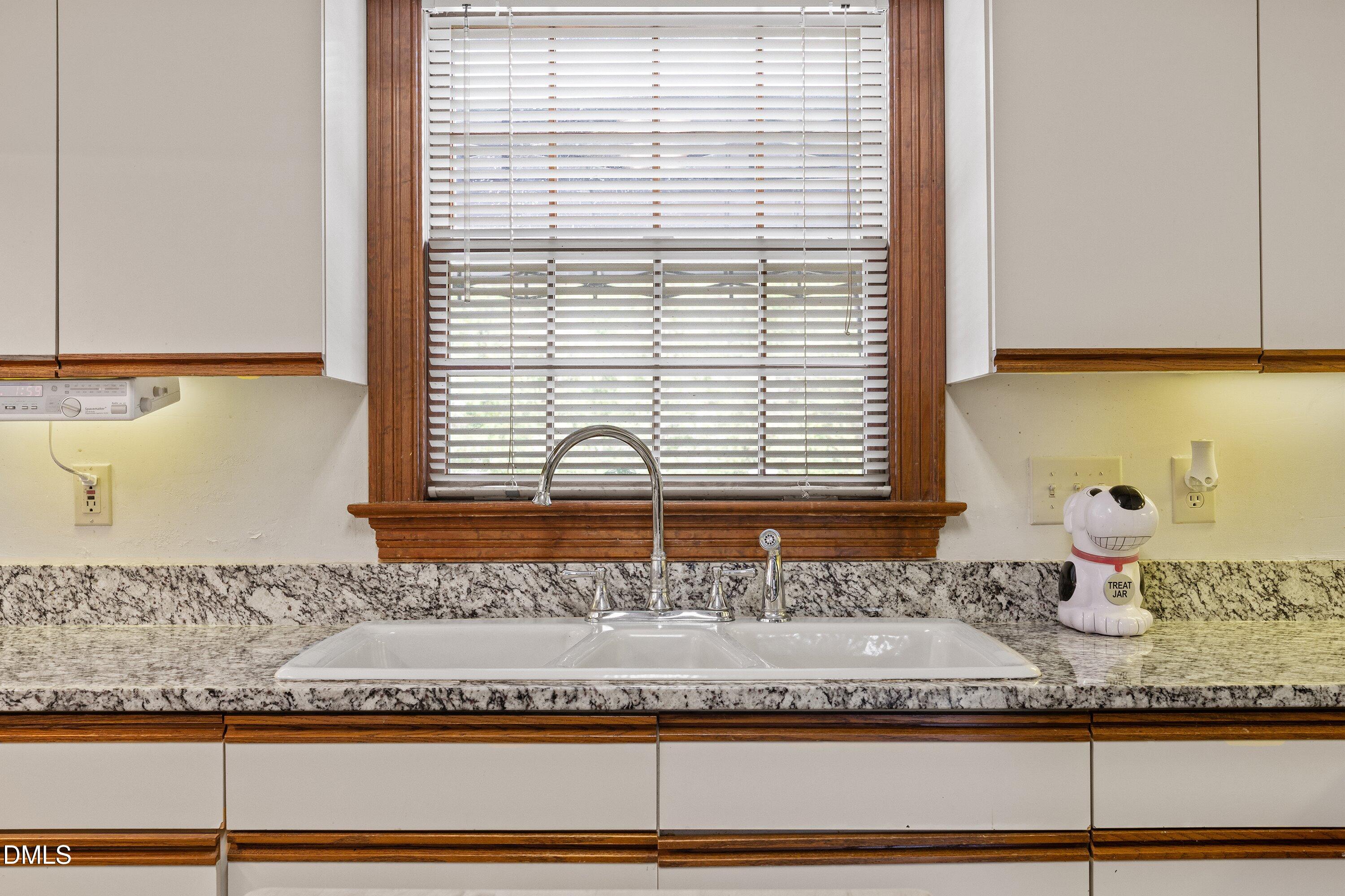 6314 Old Davis Road Sims, NC 27880 - Photo 30 of 71 a bathroom with a granite countertop window and a sink