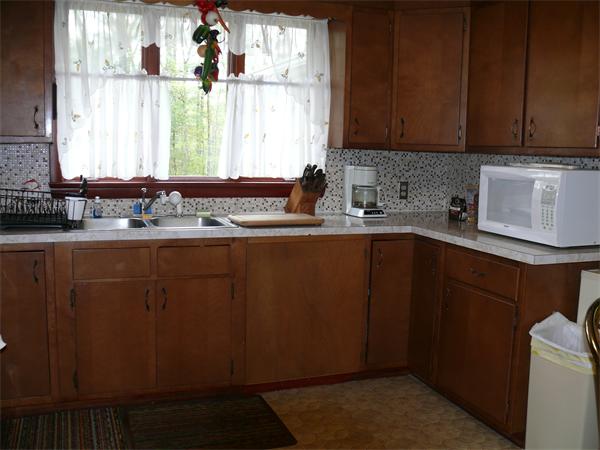 48 Horse Pond Road Shirley, MA 01464 - Photo 9 of 13 a kitchen with sink a window and cabinets