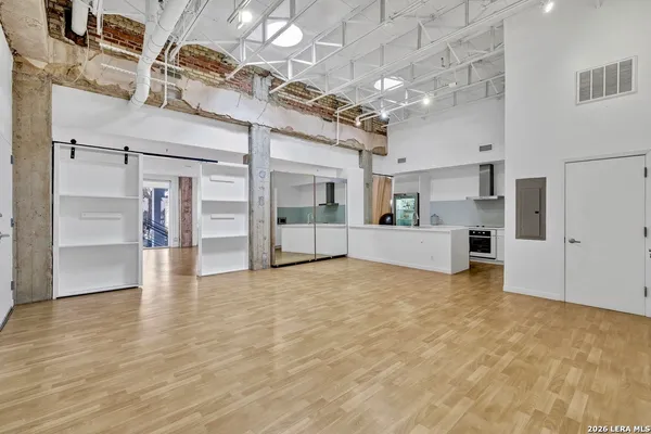 a view of a big room with wooden cabinet and refrigerator