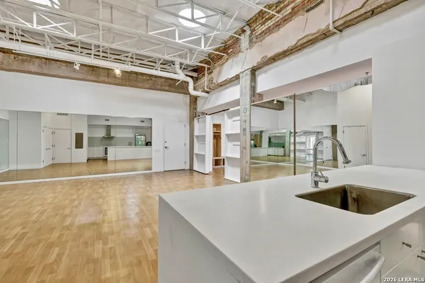 a bathroom with a sink a large mirror and vanity
