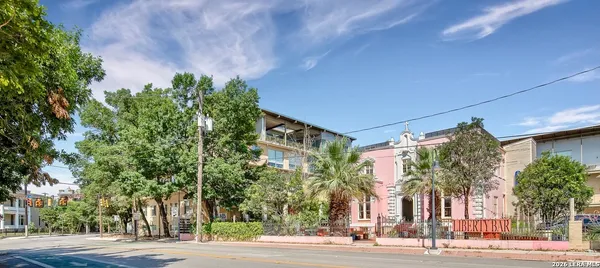 a view of a tall building next to a road