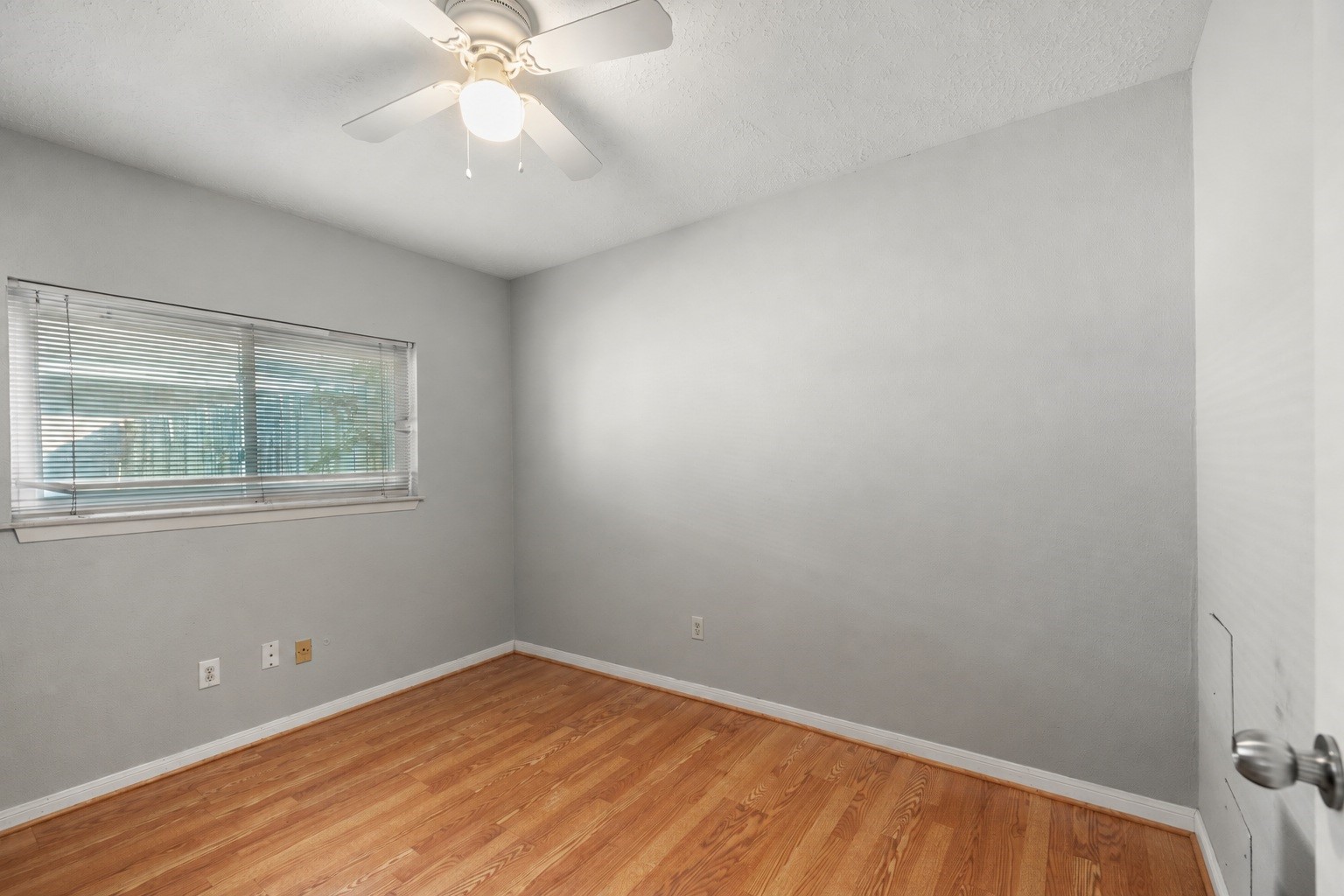 23826 Lestergate Drive Spring, TX 77373 - Photo 27 of 45 Natural light comes in through the window, while a ceiling fan adds everyday comfort overhead. Laminate flooring continues through the fourth bedroom—NO CARPET here—keeping the secondary bedrooms consistent and easy to maintain.