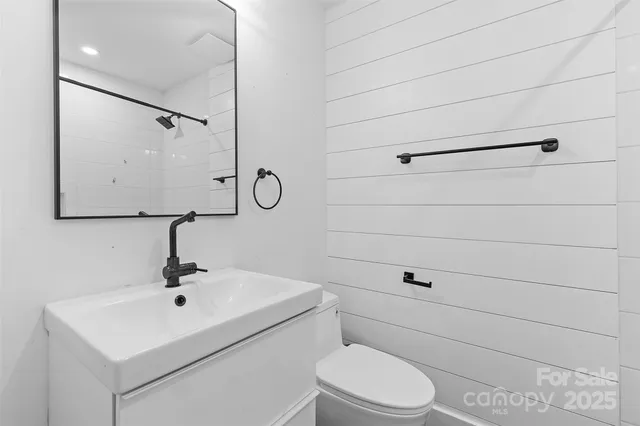 a bathroom with a sink toilet and mirror