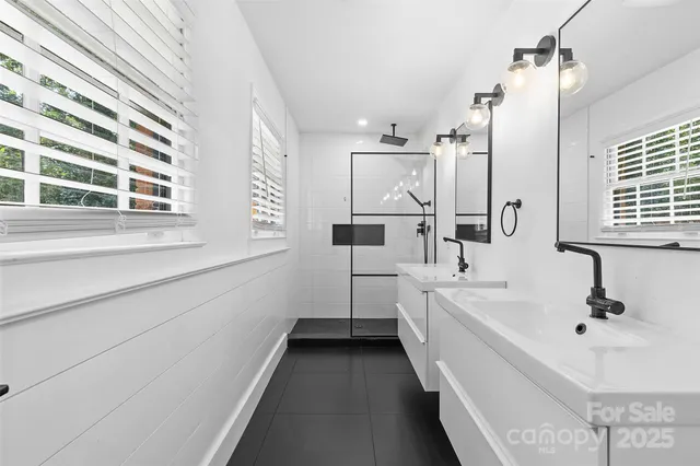 a bathroom with a bathtub sink and mirror