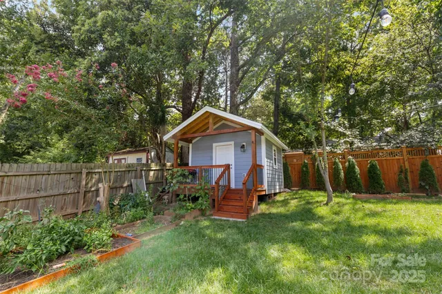 a view of backyard with small cabin