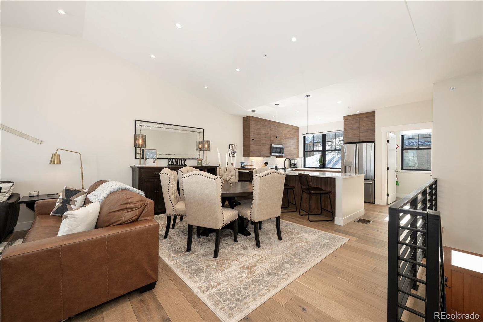 109 Saddle Mountain Camp Road Granby, CO 80446 - Photo 12 of 50 a living room with furniture a rug and kitchen view