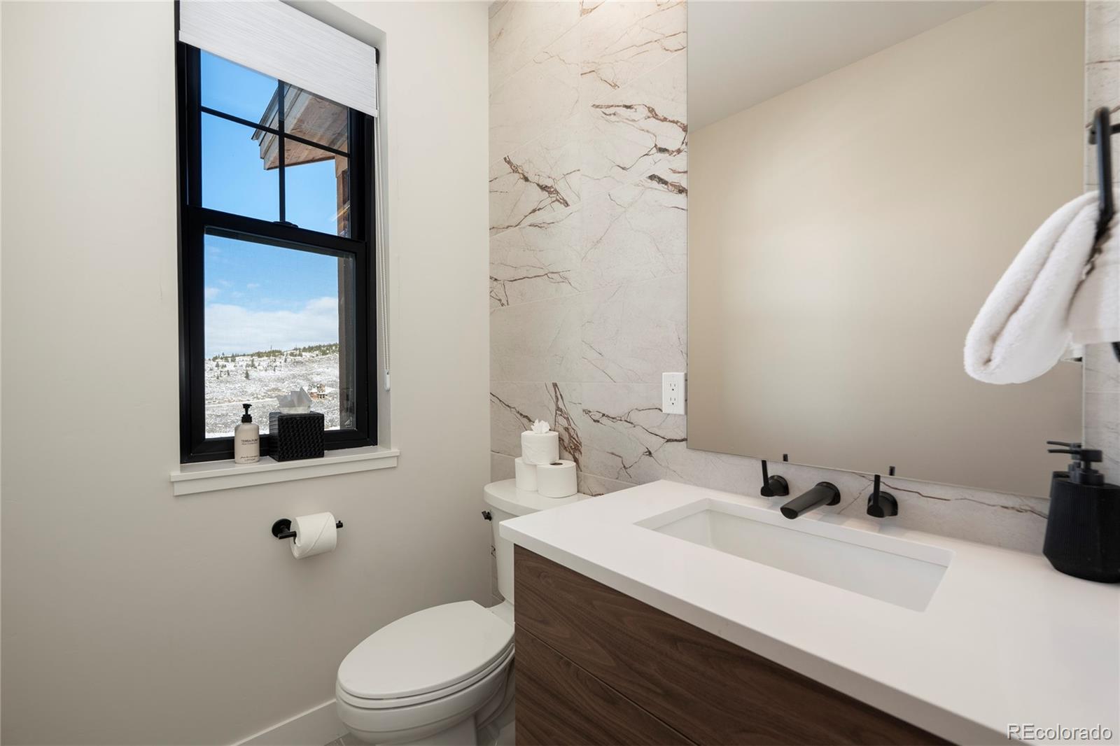 109 Saddle Mountain Camp Road Granby, CO 80446 - Photo 18 of 50 a bathroom with a sink a toilet and mirror