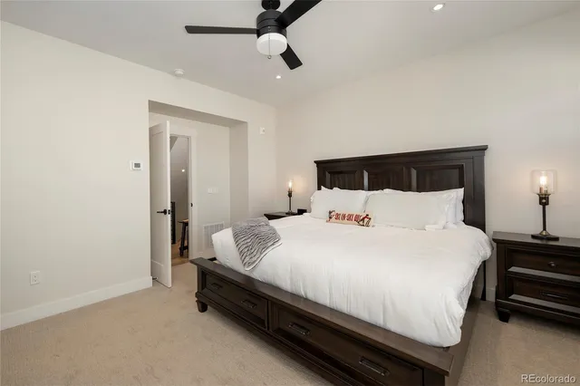 a bedroom with a bed tv and a window