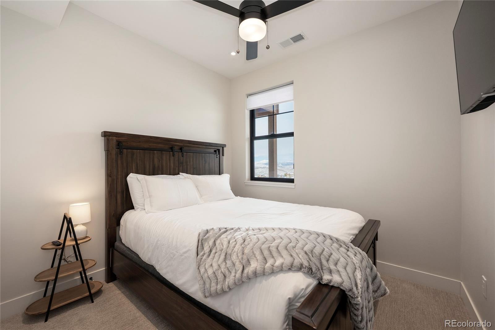 109 Saddle Mountain Camp Road Granby, CO 80446 - Photo 35 of 50 a bedroom with a bed tv and a window