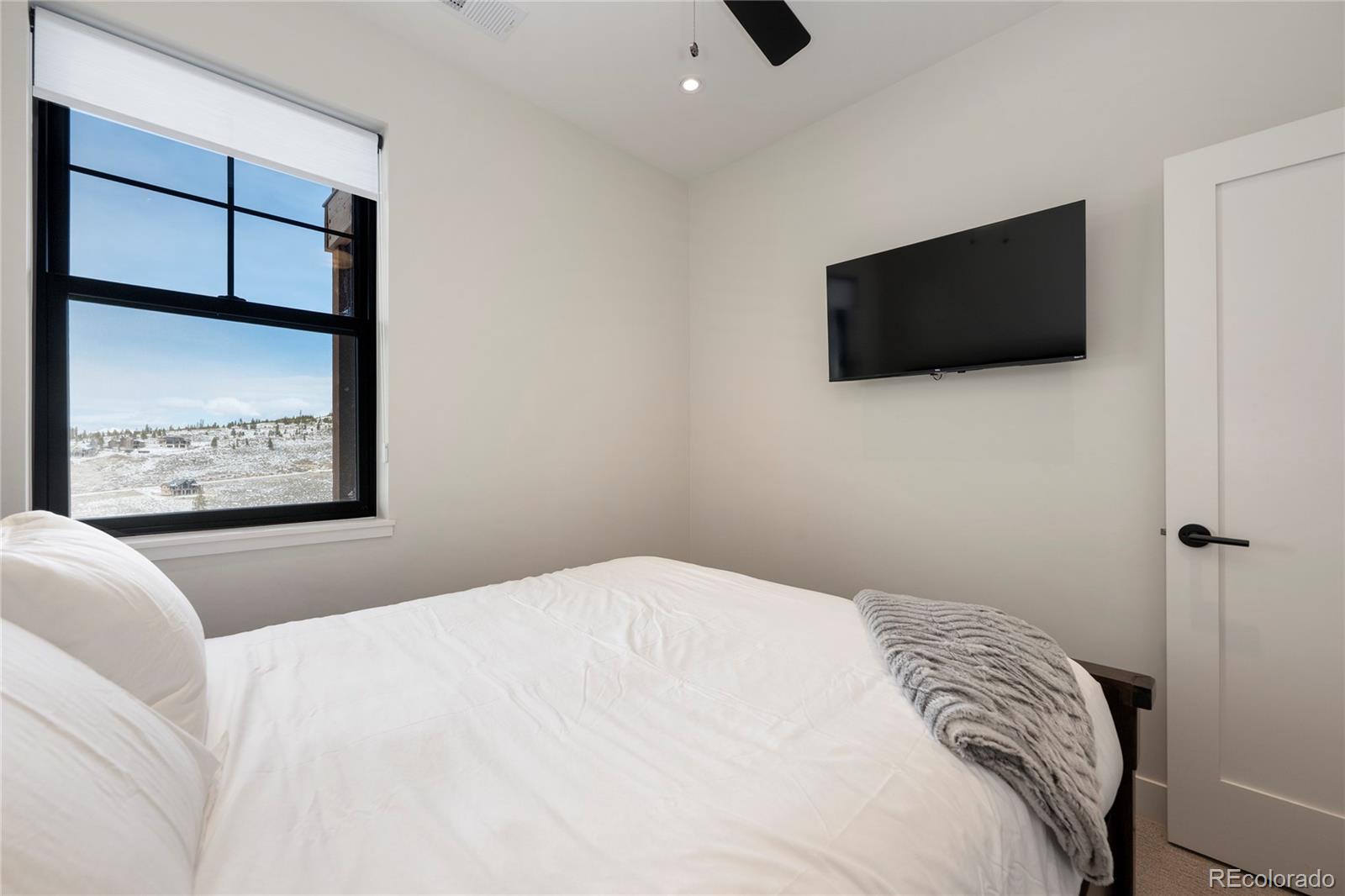 109 Saddle Mountain Camp Road Granby, CO 80446 - Photo 36 of 50 a bedroom with a bed a flat screen tv and guitar