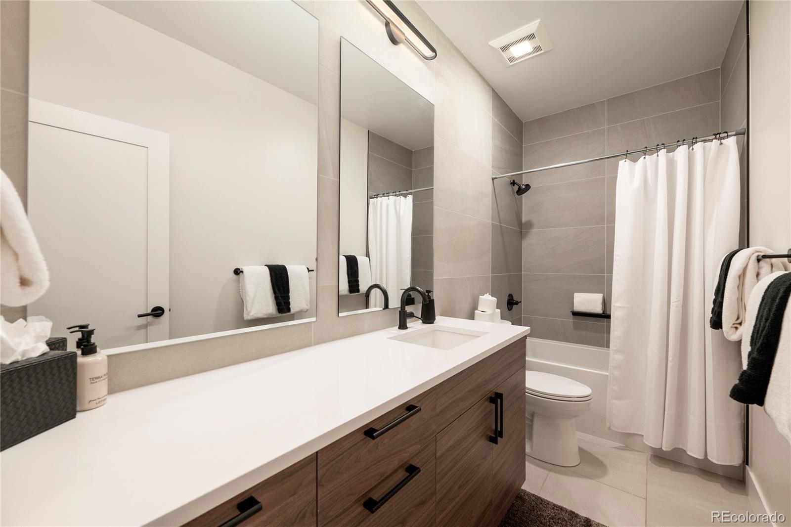 109 Saddle Mountain Camp Road Granby, CO 80446 - Photo 39 of 50 a bathroom with a sink a toilet a mirror and shower