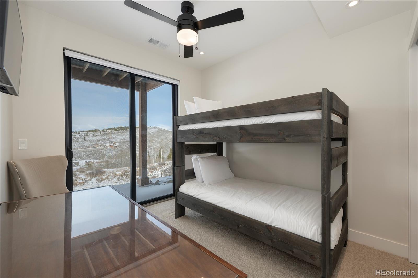 109 Saddle Mountain Camp Road Granby, CO 80446 - Photo 40 of 50 a bedroom with a large bed and a large window