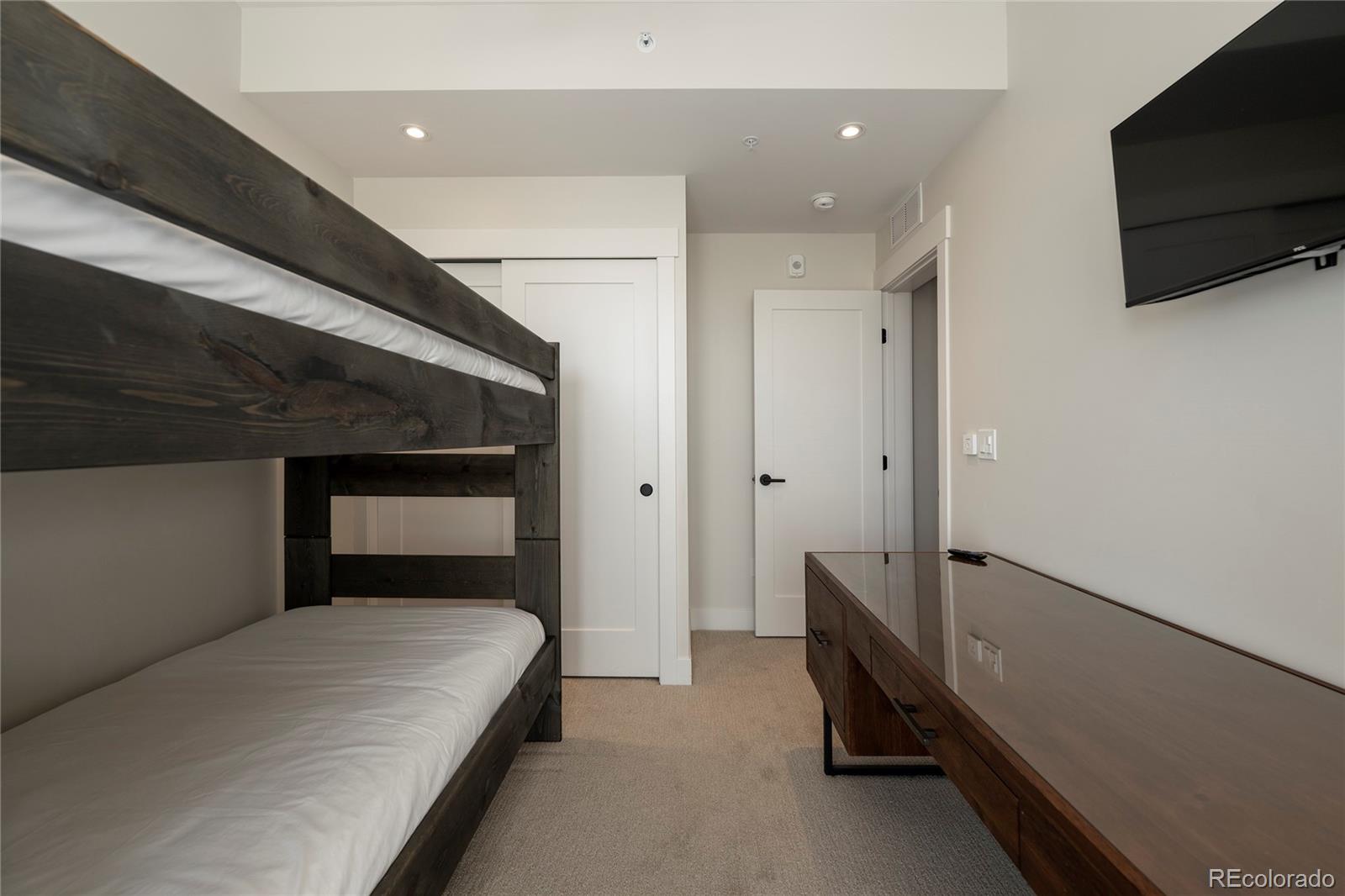 109 Saddle Mountain Camp Road Granby, CO 80446 - Photo 41 of 50 a bedroom with a bed and a flat screen tv