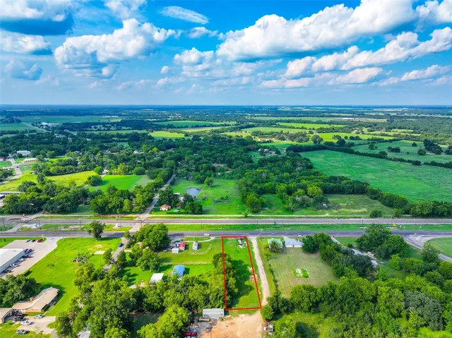 a view of a big yard with lots of green space