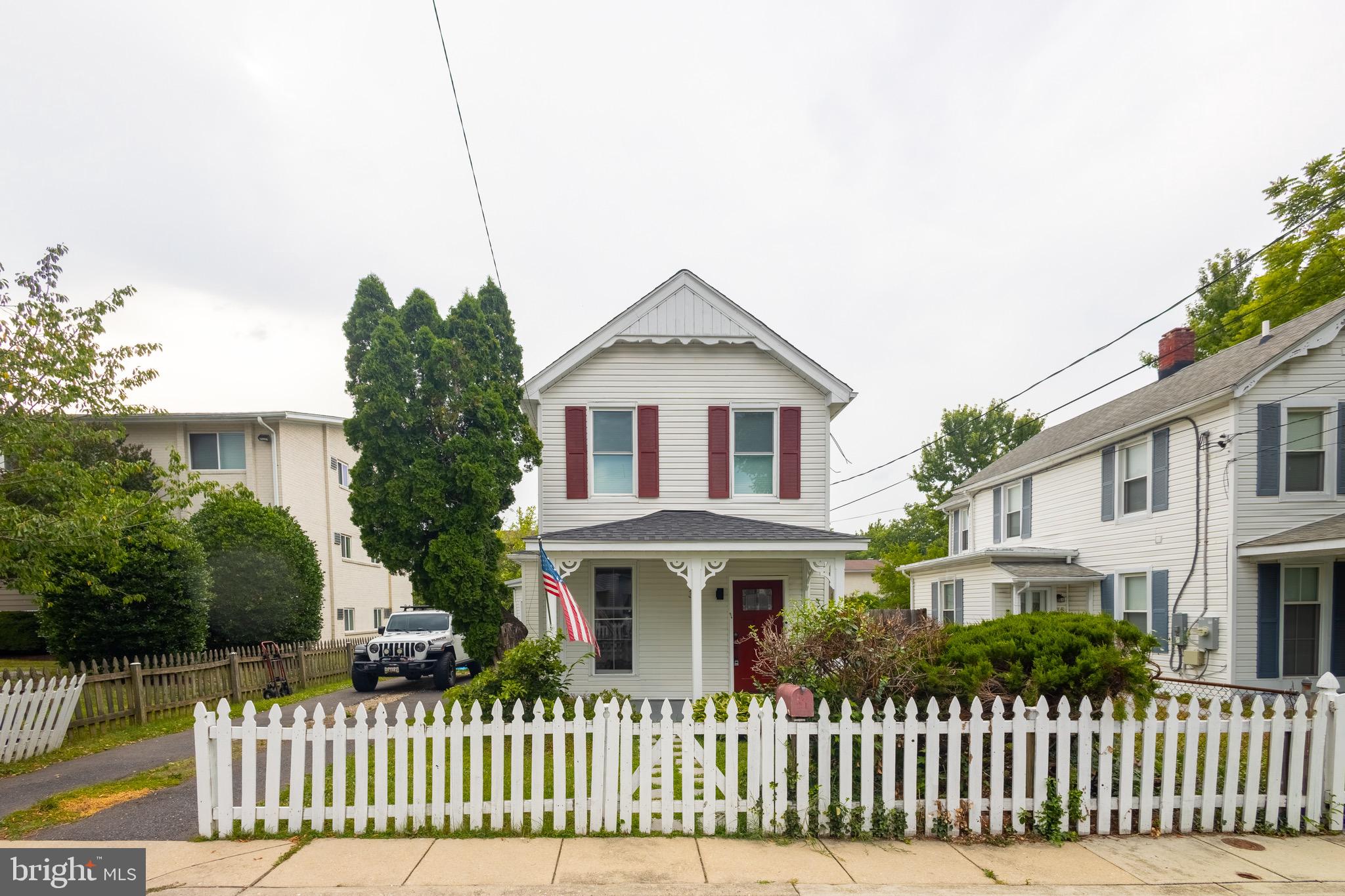 37 4th Street Laurel, MD 20707 - Photo 2 of 26 a front view of a house with a garden