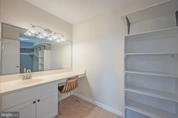a spacious bathroom with a sink and a mirror