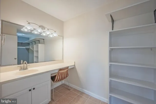 a spacious bathroom with a sink and a mirror